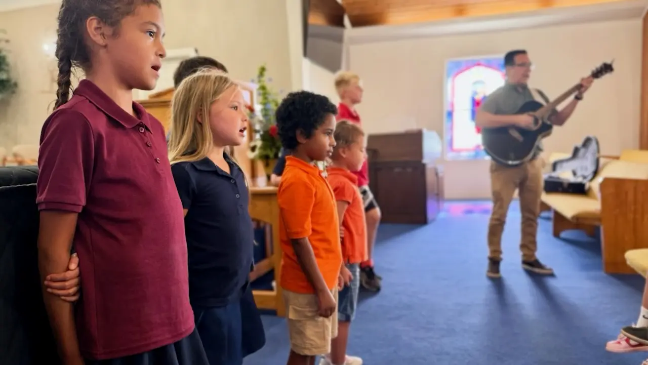 Students singing at weekly chapel service